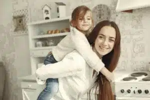 woman giving daughter piggyback ride